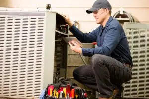 HVAC technician checking on HVAC system